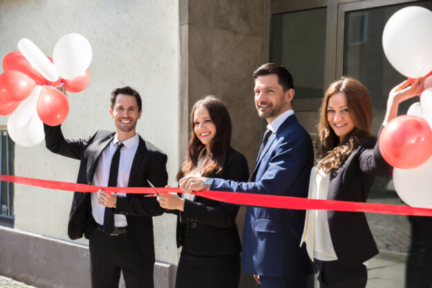 Portrait,Of,Smiling,Young,Businesspeople,Cutting,Red,Ribbon 3 Tips for Starting a Small Business in 2022