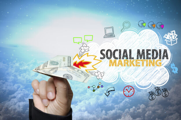 Businessman,Hand,Holding,Dollar,Plane,With,Social,Media,Marketing,Text